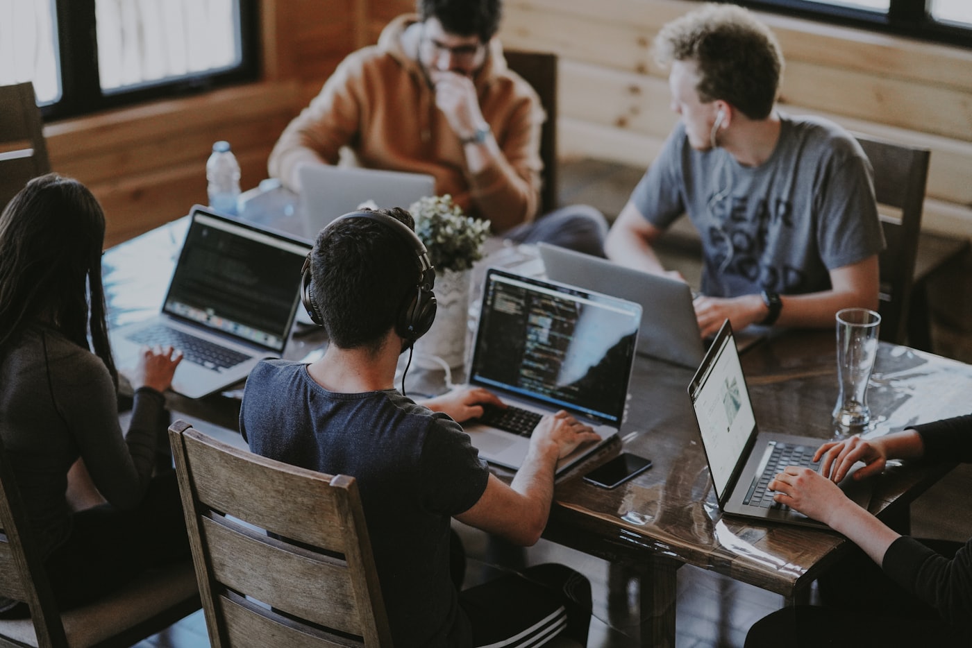 Group of people around laptops in a meeting